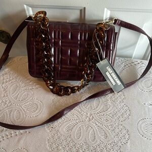 Cross Shoulder or Shoulder bag in a wine color.